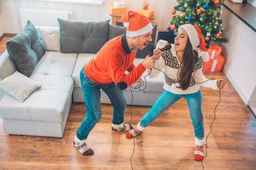 young couple singing christmas songs together