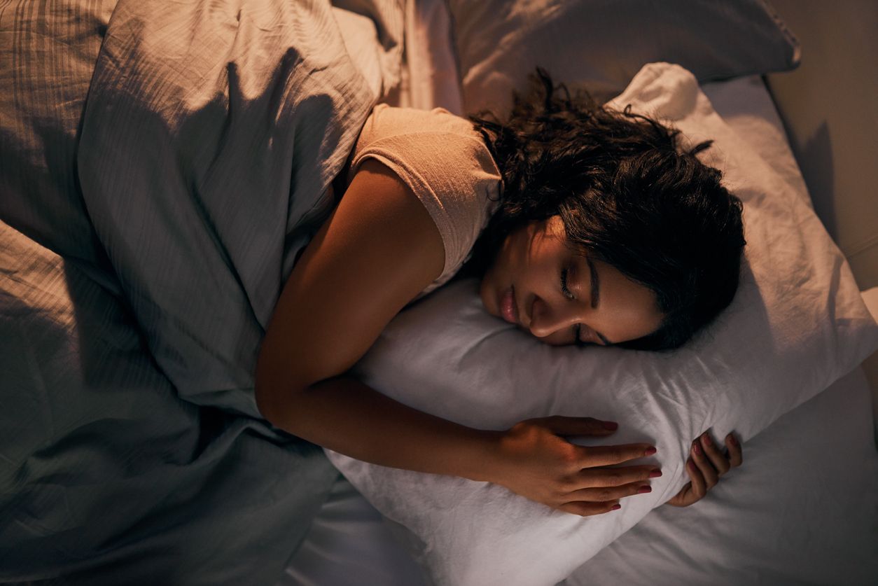 Woman getting a good night's sleep in bed.