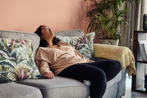 Shot of a young woman resting on the sofa at home