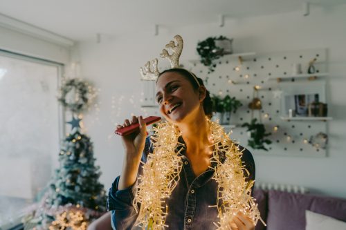 young woman decorating christmas tree