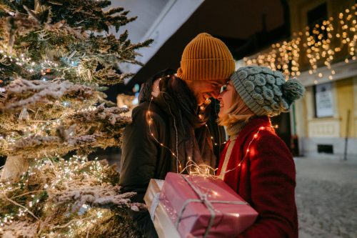 young couple exchanging Christmas gifts