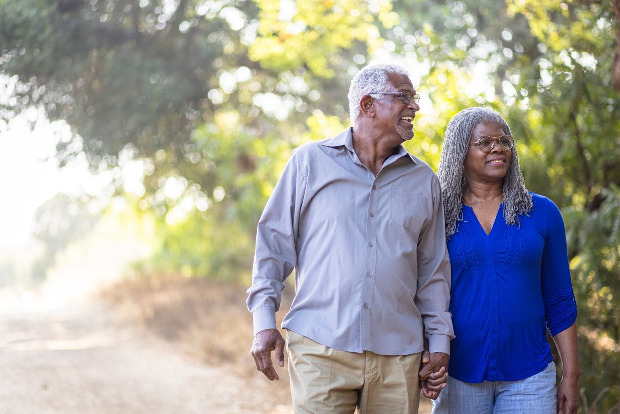 Older couple walking outdoors.