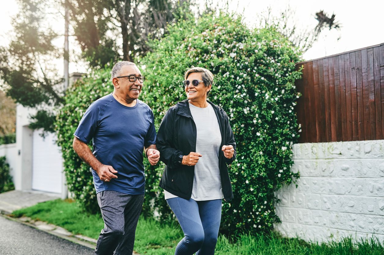 Senior couple jogging outdoors.