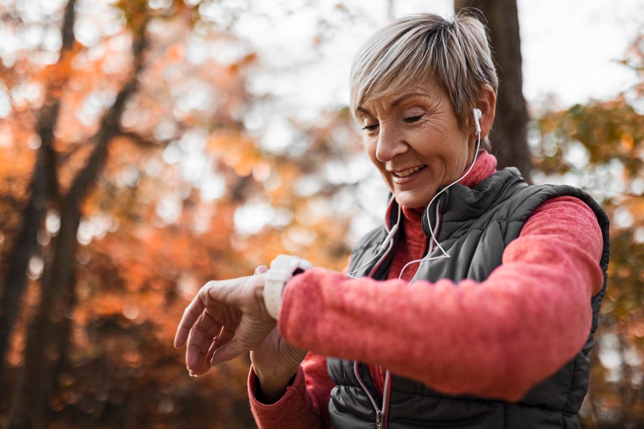 Older woman checking pulse after exercise.