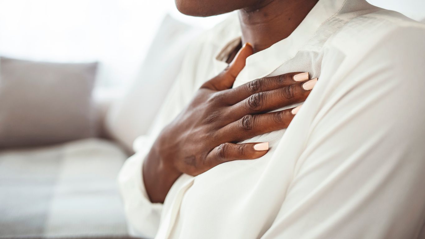 Woman with her hand over her heart.