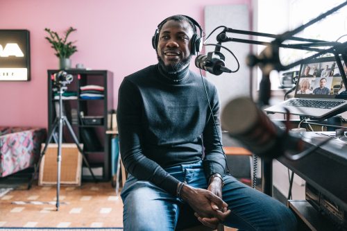 Candid portrait of African-American entrepreneur interviewed on a radio podcast.