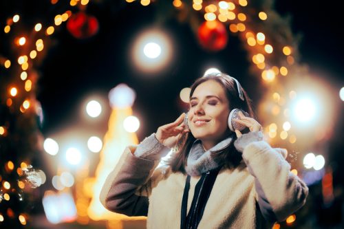 young woman listening to christmas music 