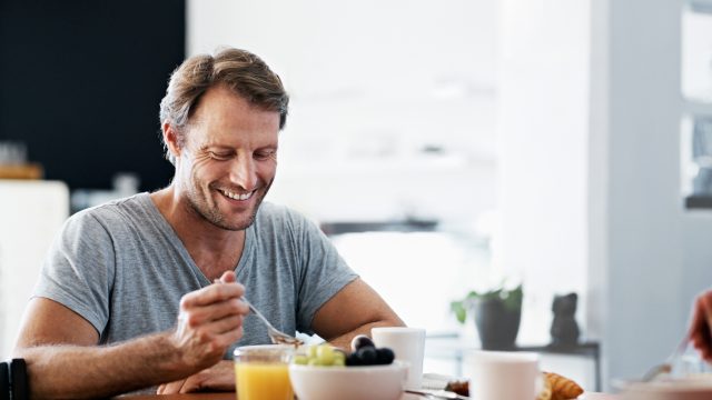 Man eating breakfast at a table.