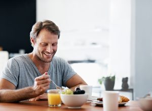 Man eating breakfast at a table.