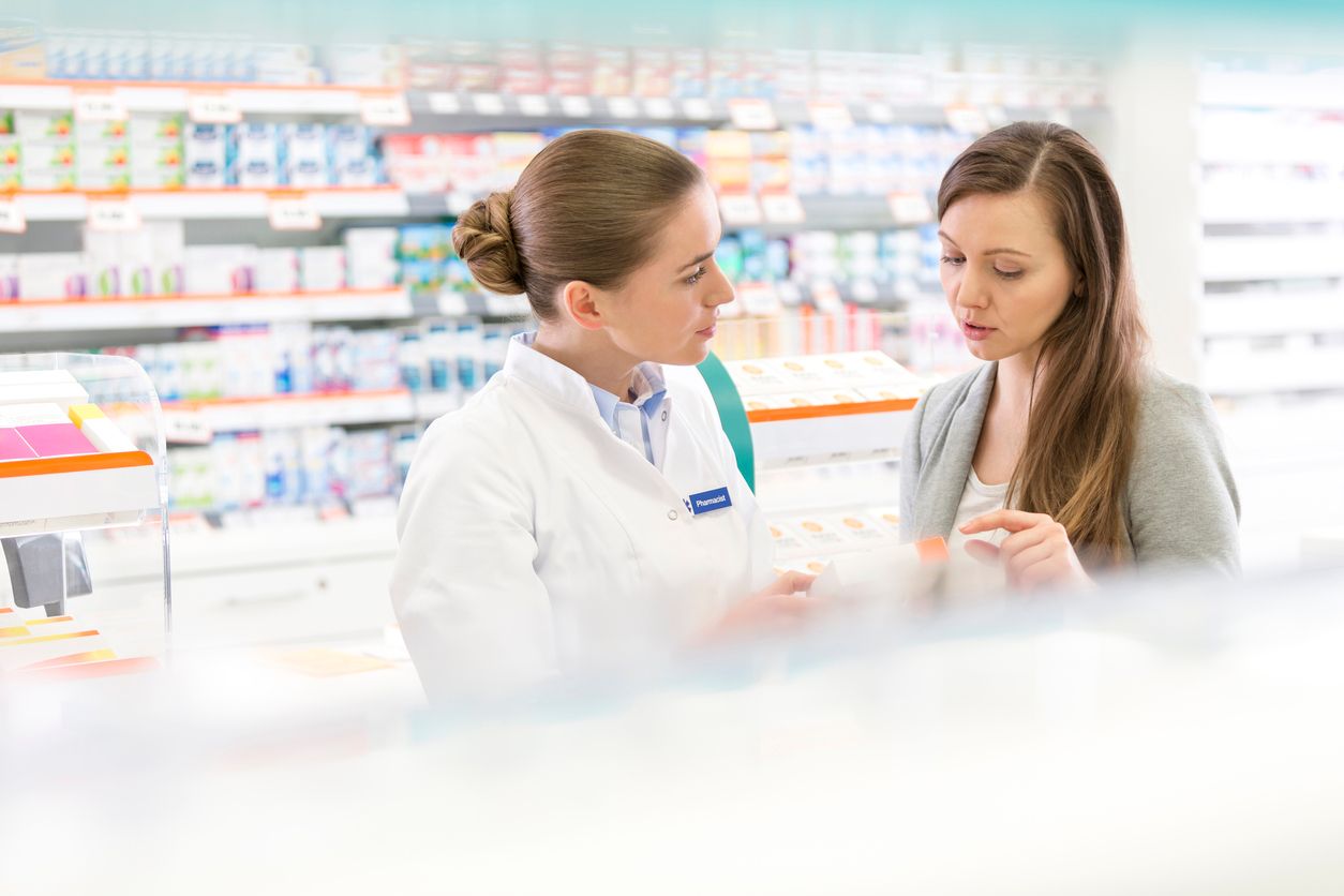 Pharmacist talking to customer.