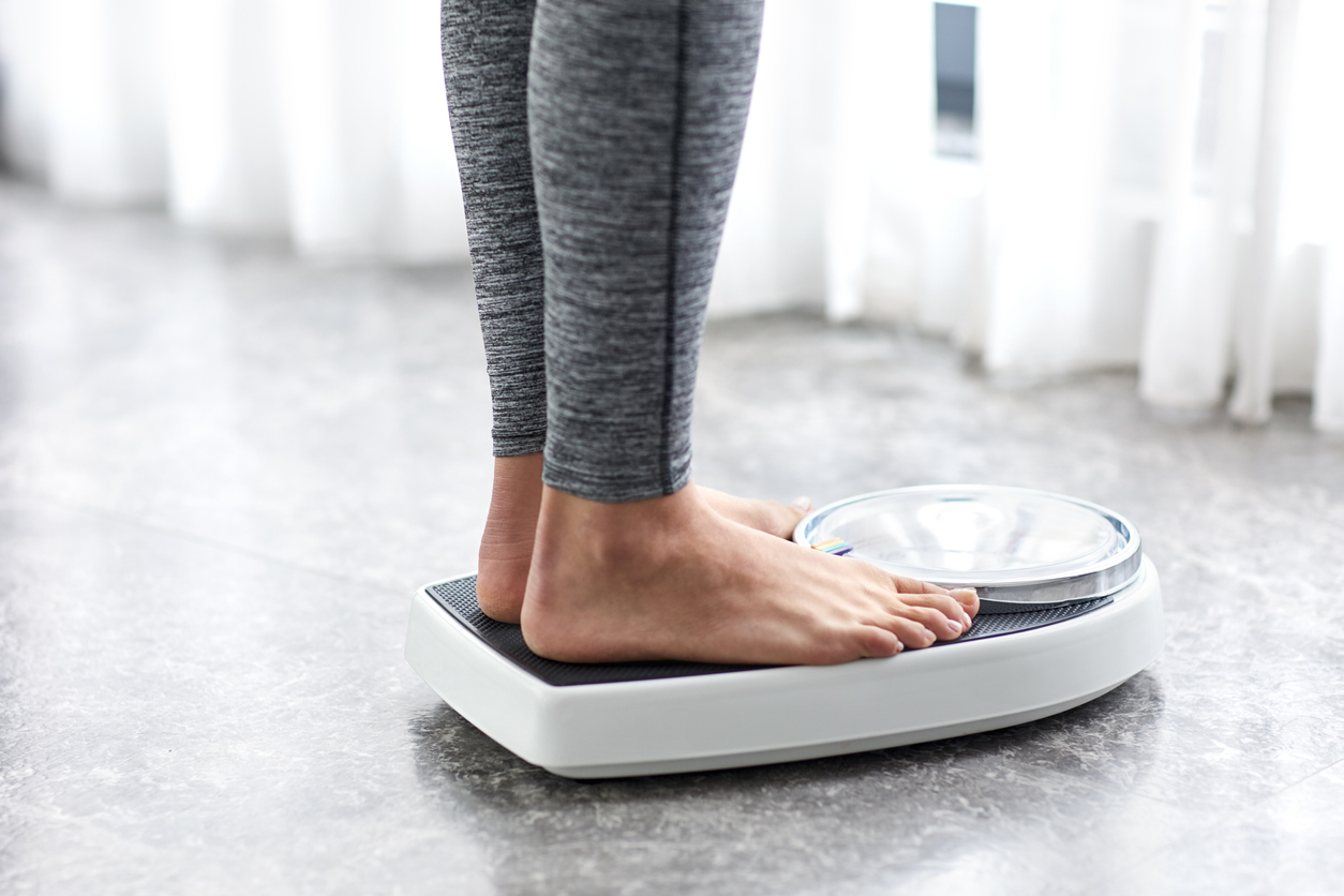 Person standing on home weight scale.