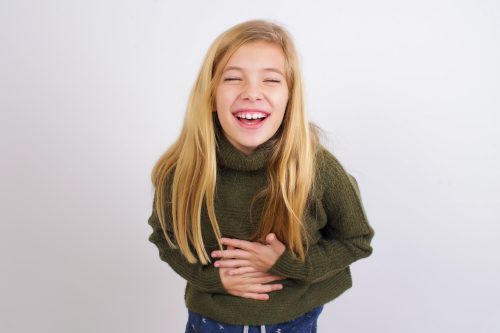 young girl laughing at hilarious knock-knock jokes
