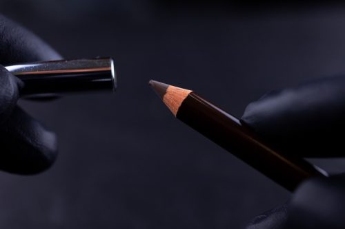 close-up of powdery eyebrow pencil on a black background