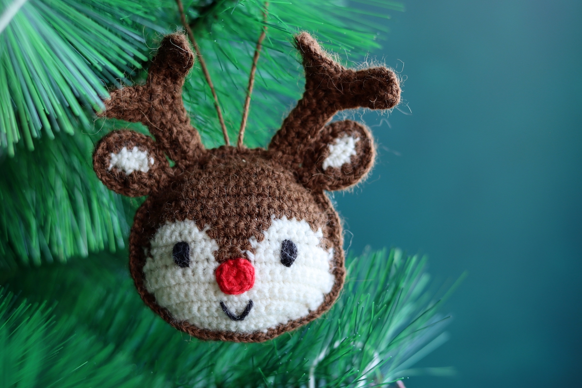 Close up of a crocheted Rudolph Christmas ornament.