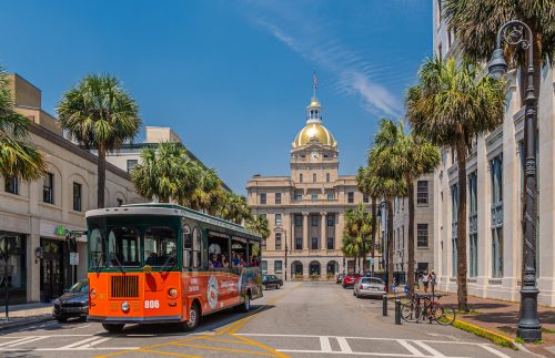 A view of the historic architecture and trolley in Savannah, Georgia. 