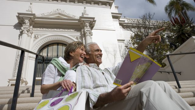 A senior couple sitting on the steps of Balboa Park in San Diego, California.