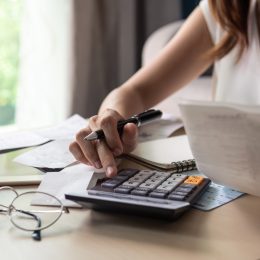 woman calculating monthly expenses
