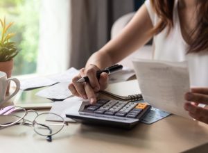 woman calculating monthly expenses