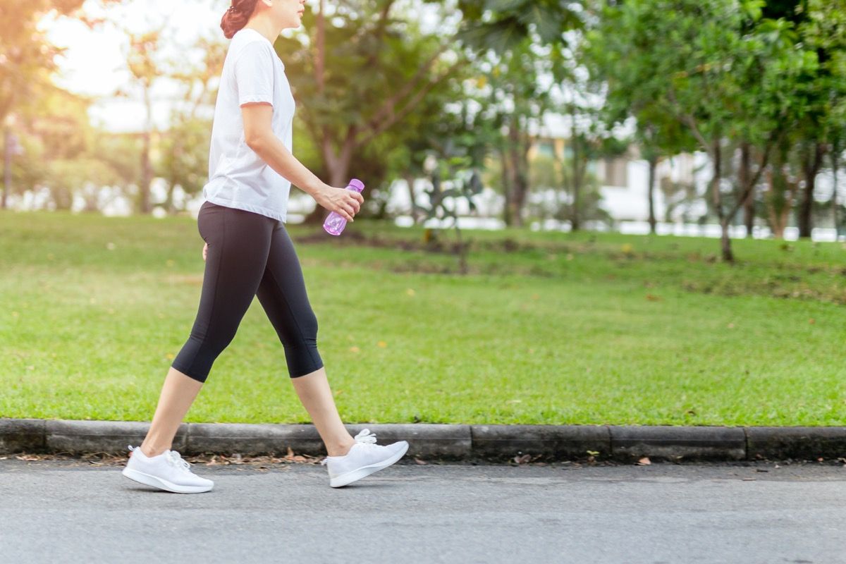 A woman jogging with a water bottle.