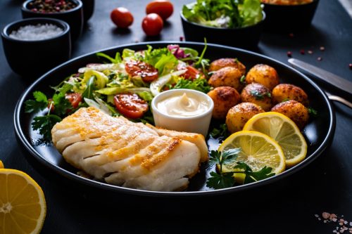 potatoes with fish and salad