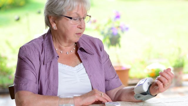 older woman measuring blood pressure