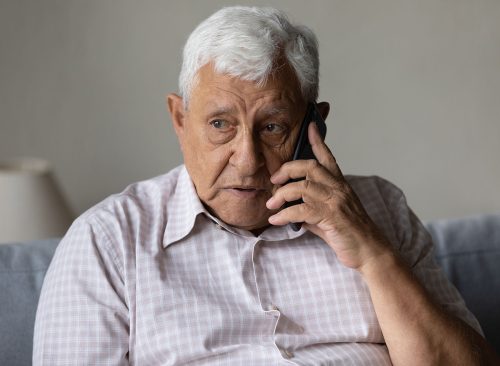 concerned older man on the phone