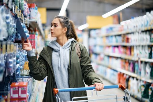 woman looking at prices while shopping