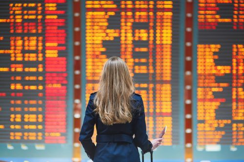 woman looking at canceled flight schedule