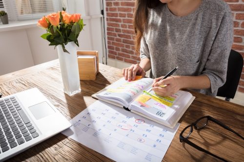 woman filling out planner