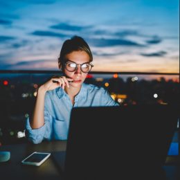 hardworking woman in office at night