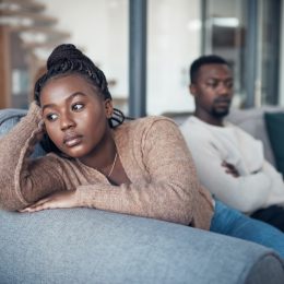 Cropped shot of a young couple sitting on the sofa and giving each other the silent treatment after an argument