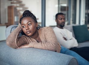 Cropped shot of a young couple sitting on the sofa and giving each other the silent treatment after an argument