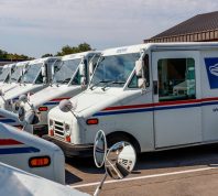 Circa August 2019: USPS Post Office Mail Trucks. The Post Office is responsible for providing mail delivery IX