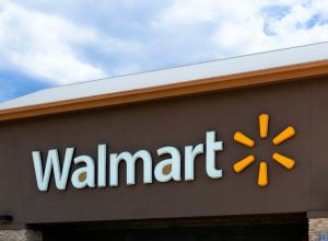 A Walmart sign from a storefront with a brown background