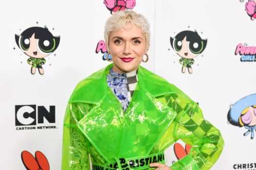 Alyson stoner at the red carpet wearing a neon green suit.