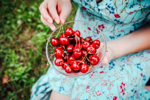 A girl picking cherries.