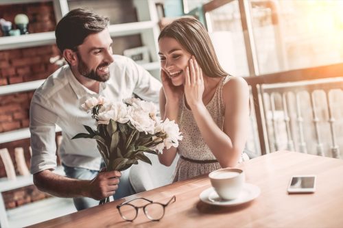 Man Surprising Girlfriend with Flowers