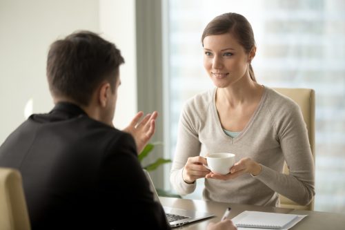 Woman Listening to Man Talking Over Coffee