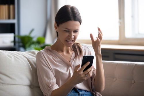 Women angry looking at her phone