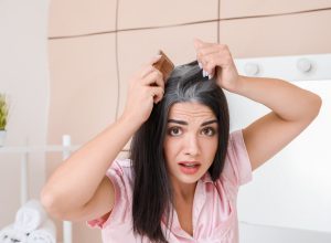 Woman coming her grey hair.
