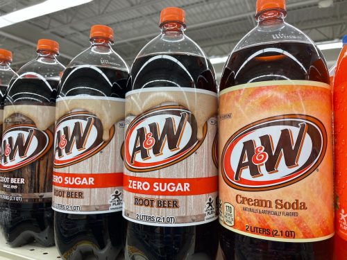 Bottles of A&W cream soda and root beer on a store shelf.