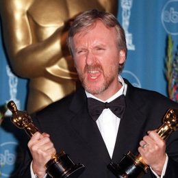 James Cameron holding two Oscars at the 1998 Academy Awards