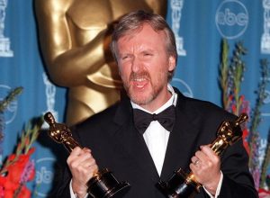 James Cameron holding two Oscars at the 1998 Academy Awards