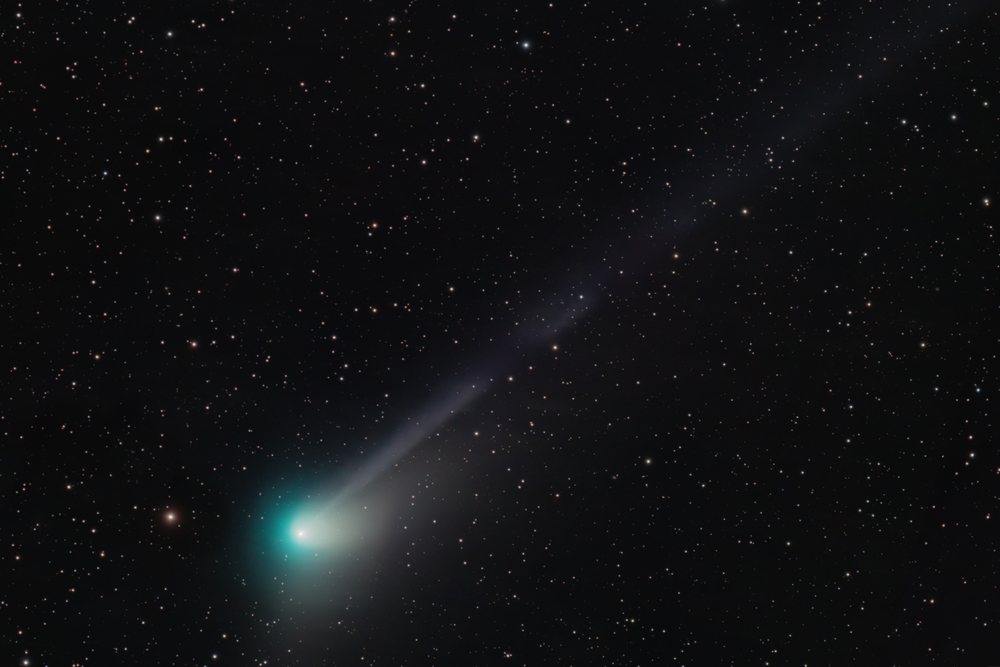 Comet C/2022 E3 (ZTF) passing in the sky overhead with a green hue