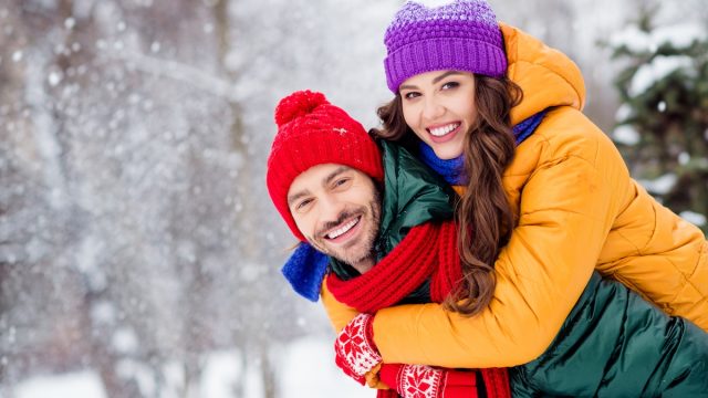 Couple wearing down jackets in the snow