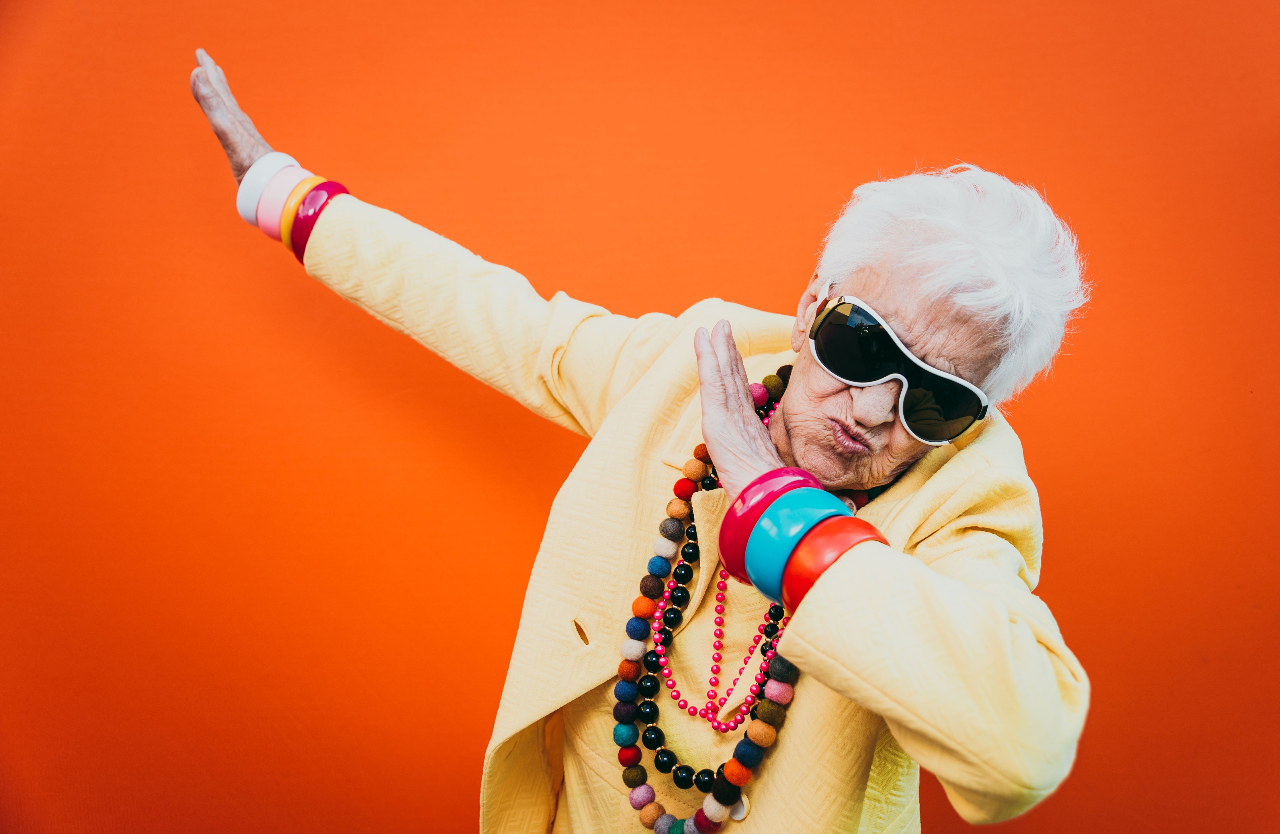 retired woman acting silly and dancing