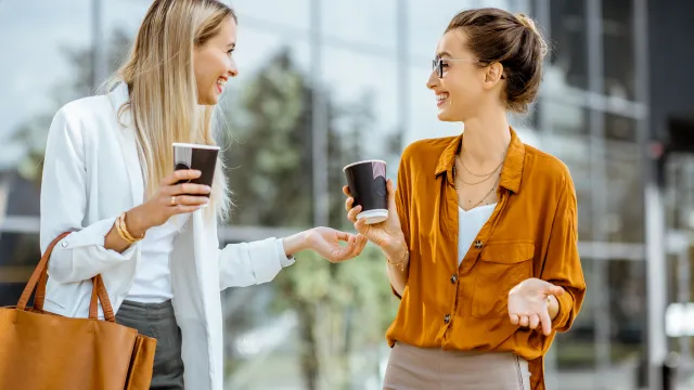 two women getting to know each other while drinking coffee