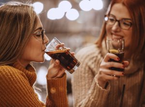Close-up shot of two women having a soda