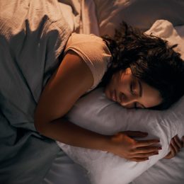 Woman having a good night of sleep in her bed.
