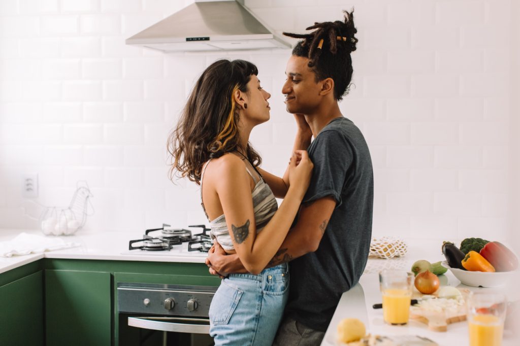 young couple hanging out together in the kitchen